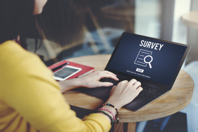 Person completing survey on laptop screen